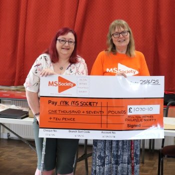 Pauline presenting cheque to MS Society from Milton Keynes Stamp Club